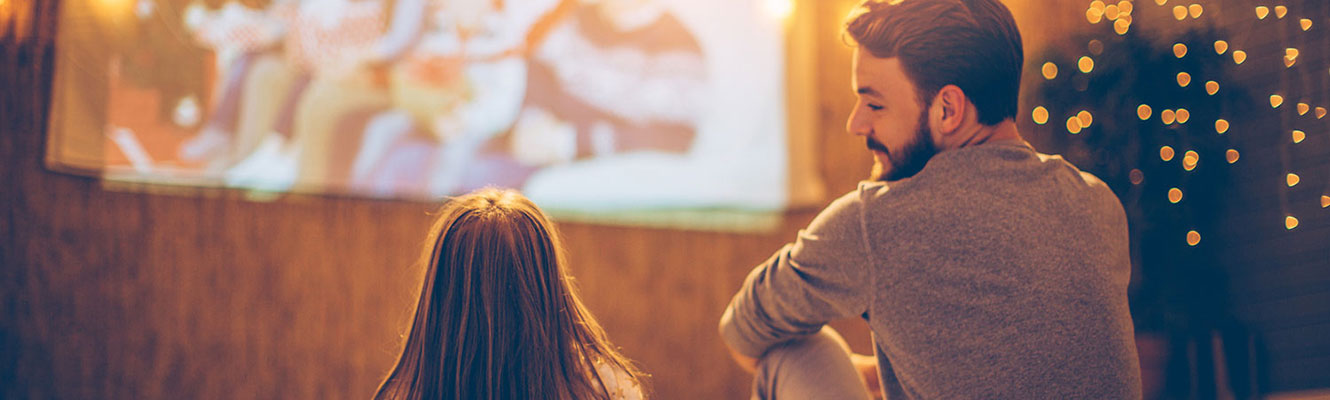 Father and daughter watching tv.