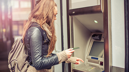 Woman using ATM.