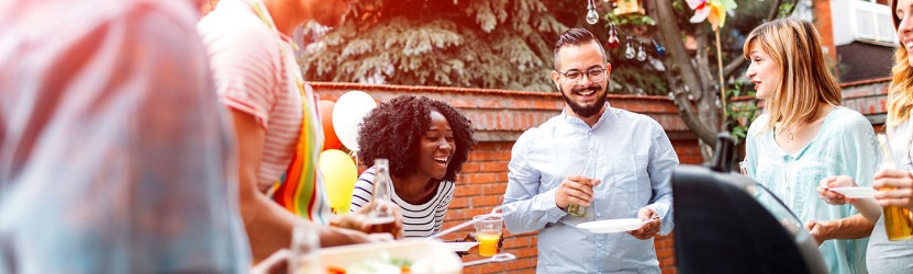 Friends enjoying barbecue outdoors.